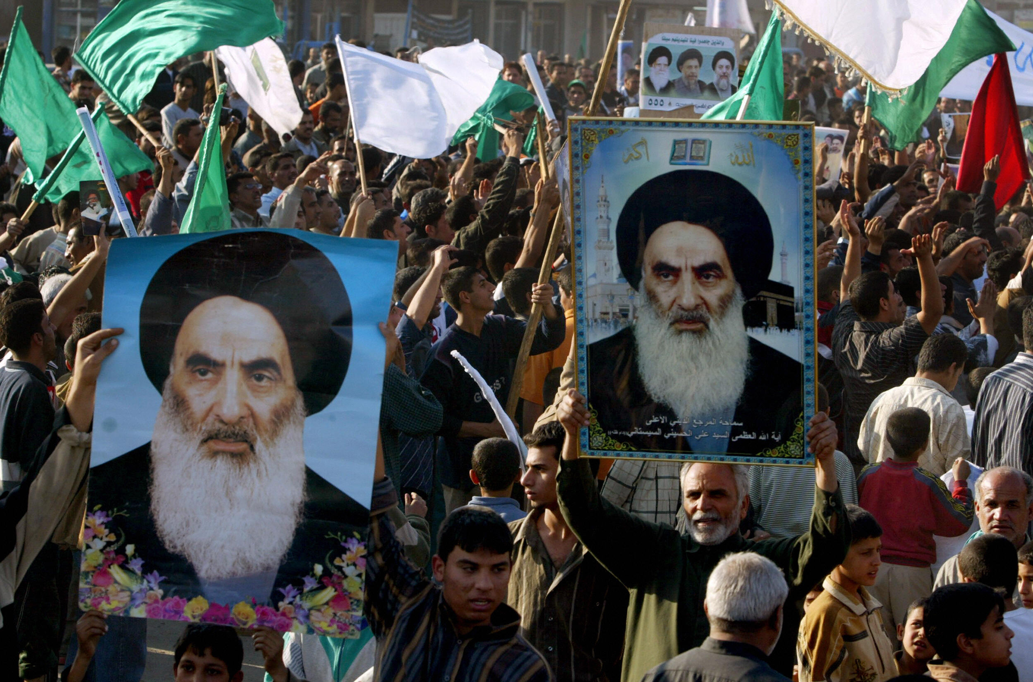 Iraqis raise pictures of Grand Ayatollah Ali al-Sistani during a demonstration in Baghdad’s poor neighborhood of Sadr City on December 14, 2005. Photo: AHMAD AL-RUBAYE/AFP